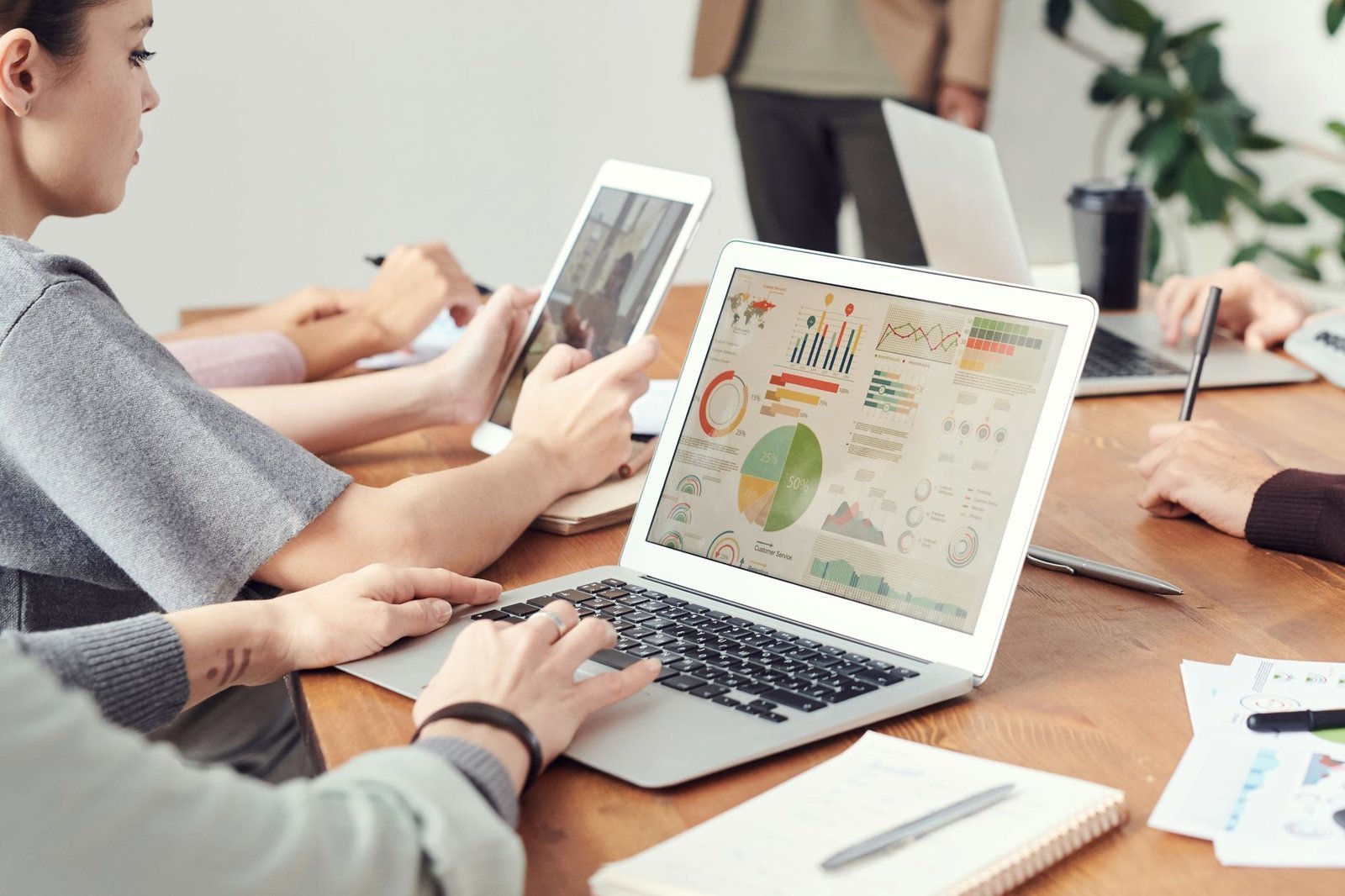 A laptop showing project management software sits on a small business office desk.