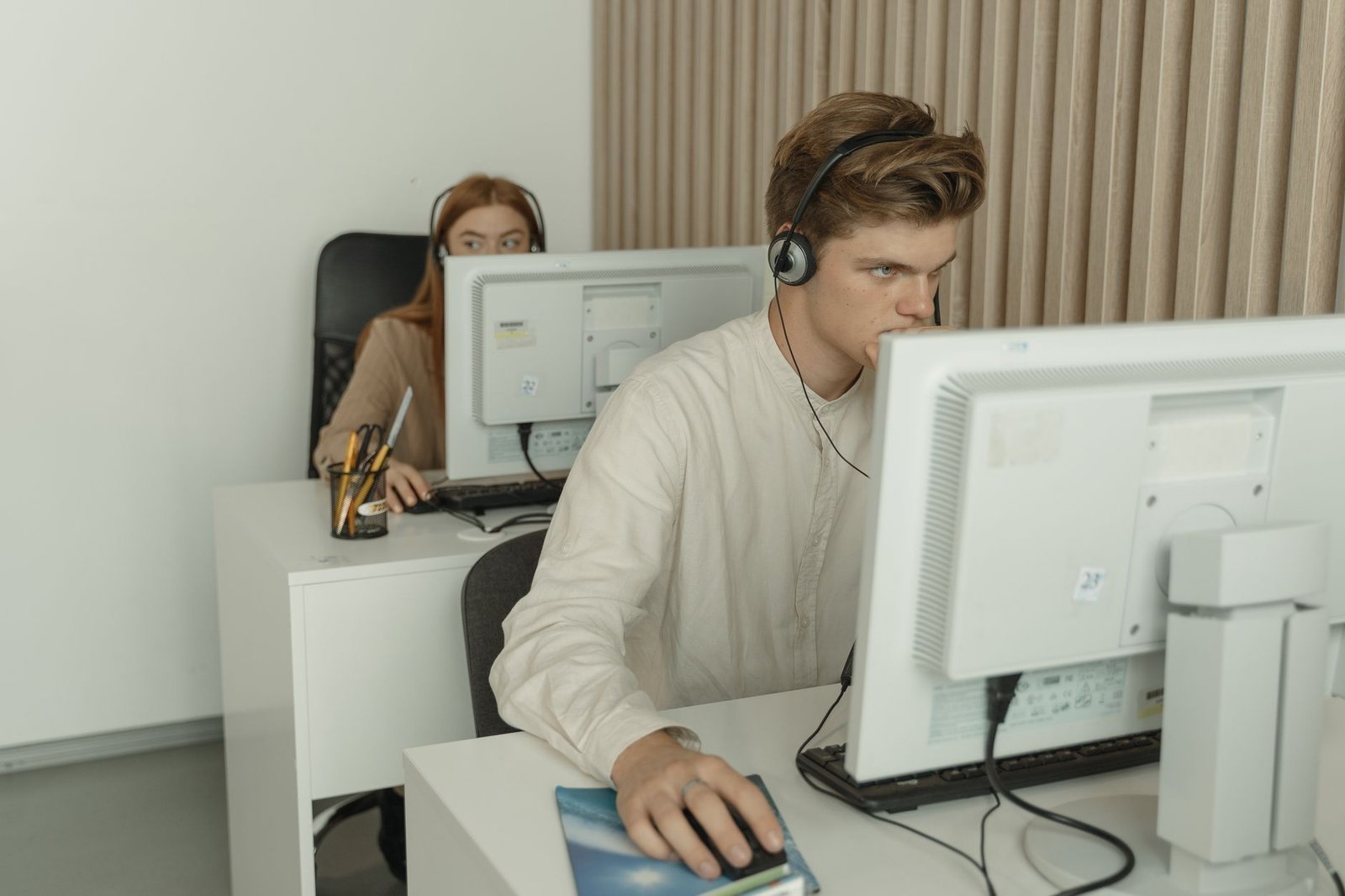 A modern home office setup showing a laptop with customer support software displayed.