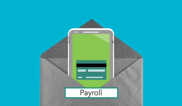 A silver laptop sits on a tidy desk beside paper invoices.