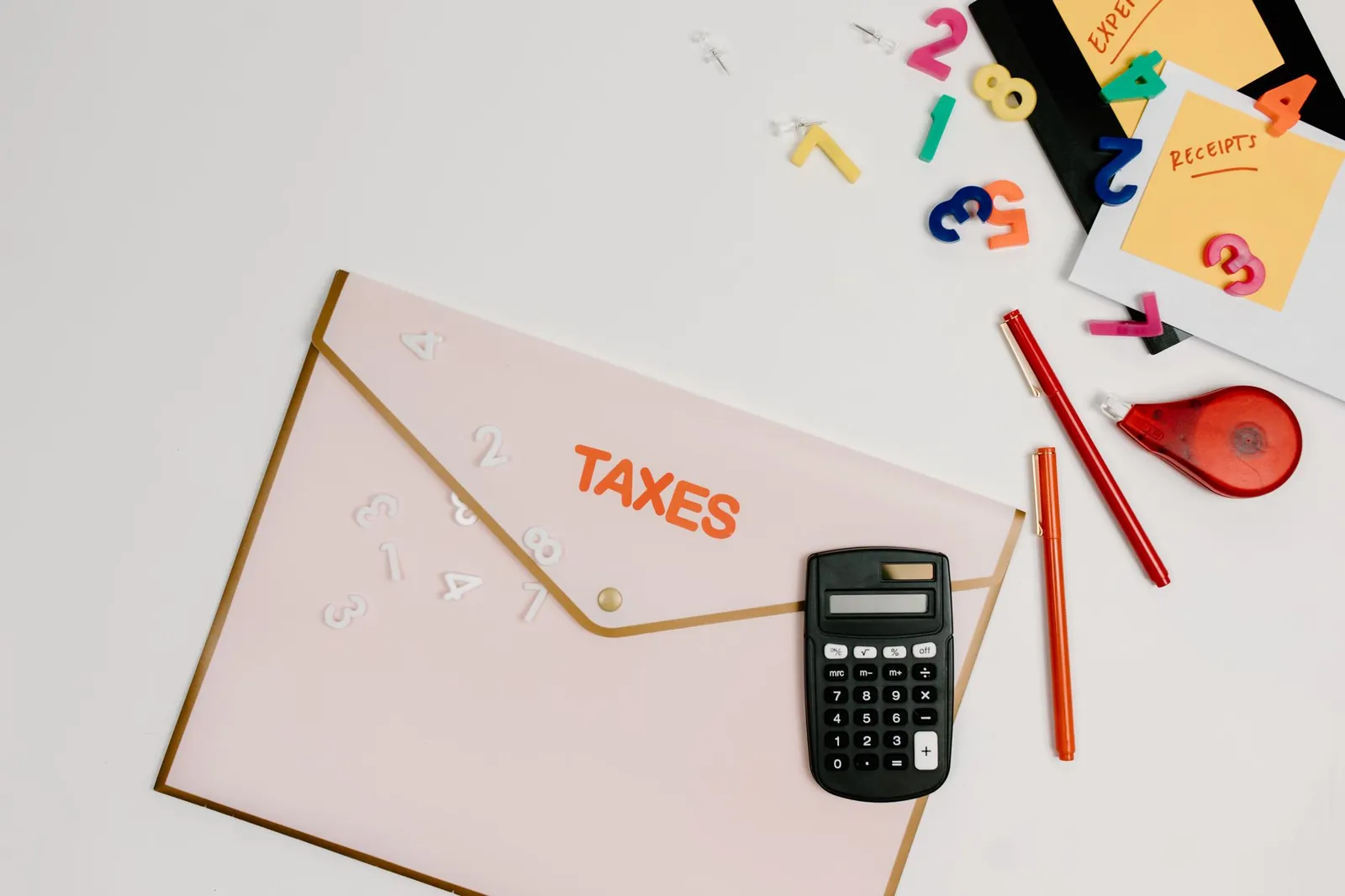 A tablet and shipping box on a desk representing small business accounting software needs.